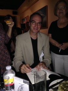 Richard Newman signing books at the Tavern of Fine Arts