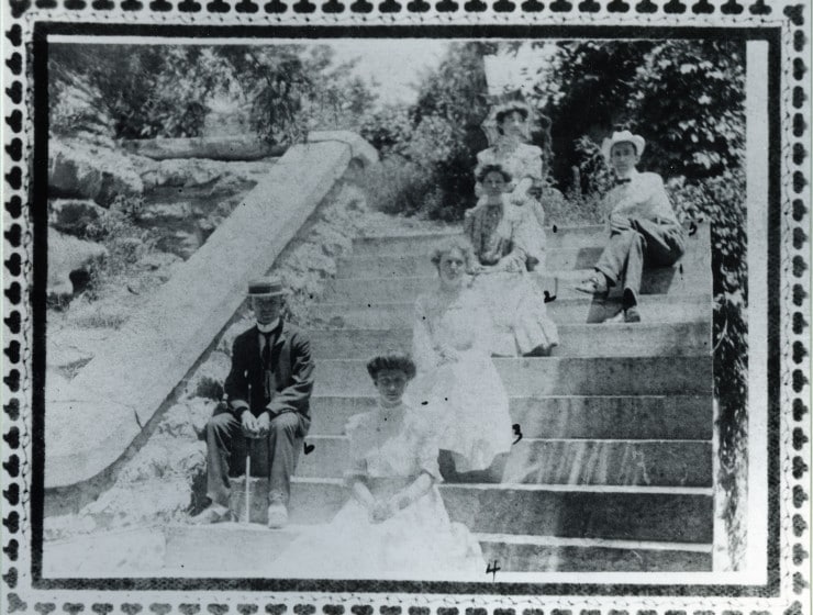 People seated on gazebo stairs - Eureka Springs Carnegie Library historic photo