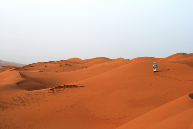 man walking in desert waterfall of sweet dreams