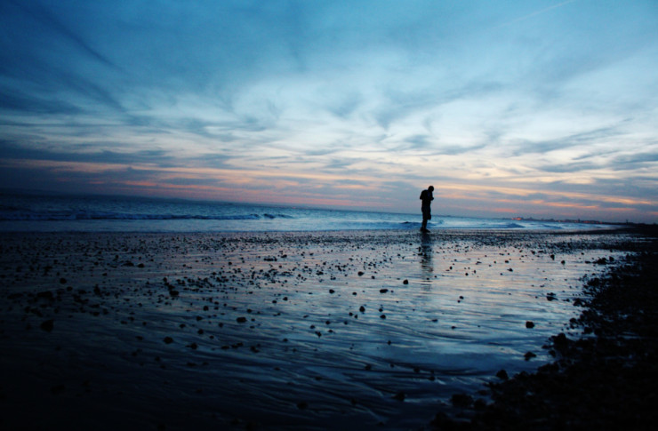 Dip into Poetry - silhouette walking on beach