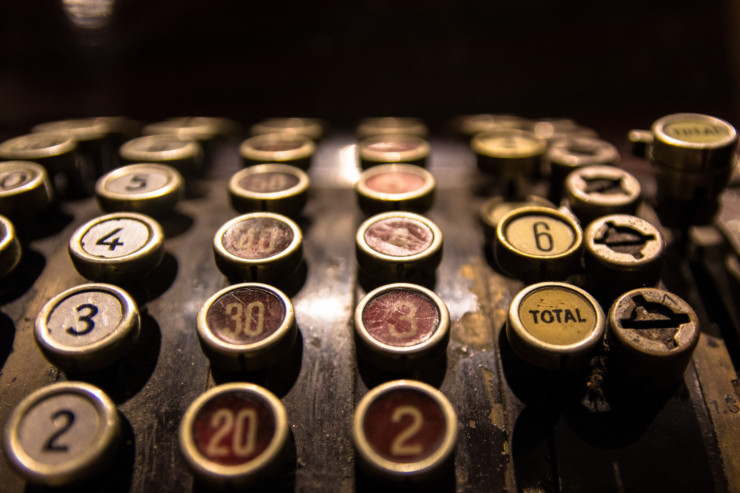 Vintage cash register top tax day haiku