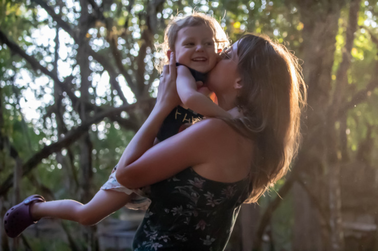 mother holding child into the air Motherload poem Kate Baer