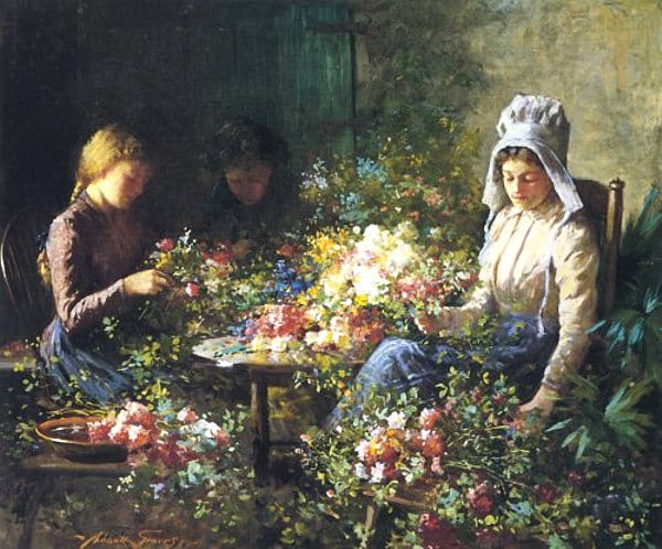 women sit around flowers of different colors to sell 