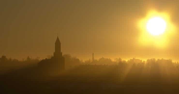 photograph on a sunrise behind a church