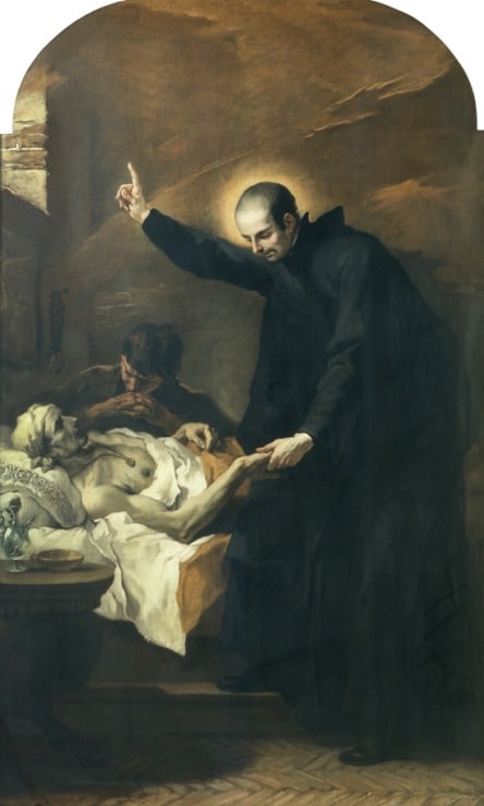 priest comforting dying man