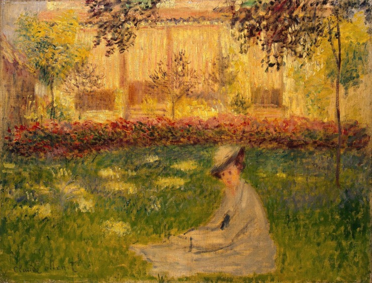 woman sits in a garden 