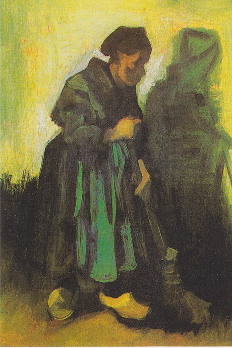 woman in green sweeps the ground with a broom