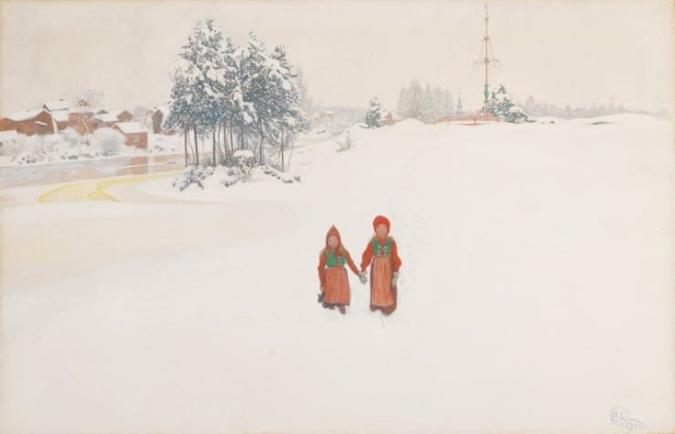two girls hold hands in orange jumpers in the snow